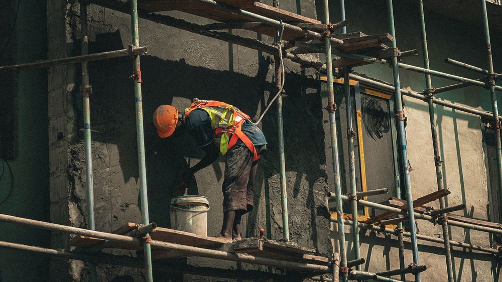 Professional applying plaster to a building facade in Abuja